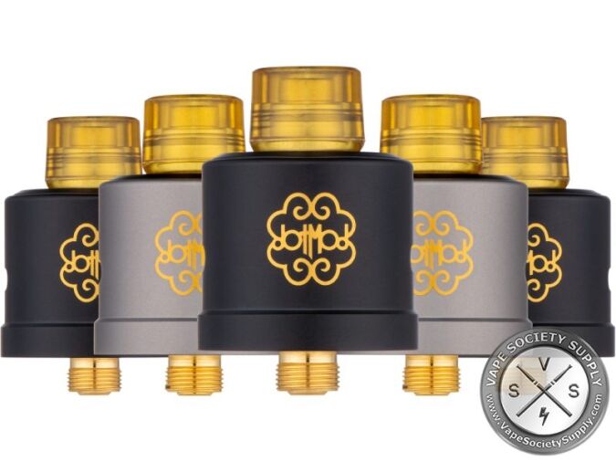 Five dotmod DotRDA X atomizers in black and gunmetal with amber drip tips and the gold dotmod logo