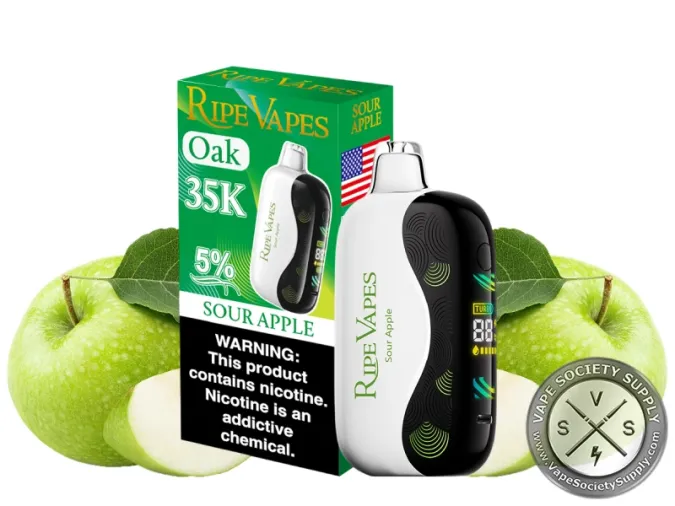 Ripe Vapes Oak 35K Sour Apple disposable vape in white with its green box, next to green apples