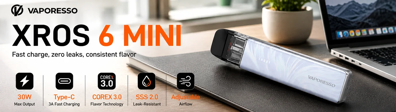 Vaporesso XROS 6 MINI Pod System banner showcasing the device on a modern office desk with 30W output, COREX 3.0 technology, leak-resistant design, USB-C fast charging, and adjustable airflow.